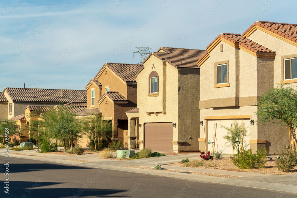 Row of modern suburban houses in a desert region in southwestern north america in Arizona with visible trees Row of modern suburban houses in a desert region in southwestern north america in Arizona with visible trees
