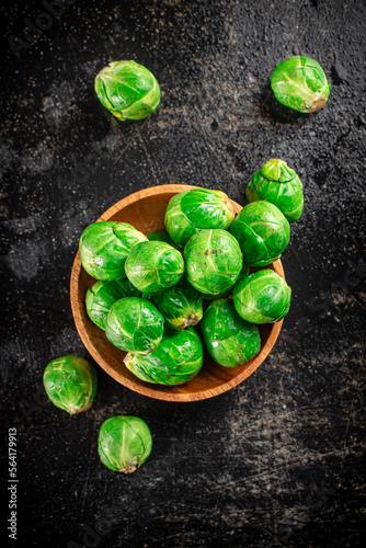 Fresh Brussels cabbage in a wooden plate.  © Artem Shadrin