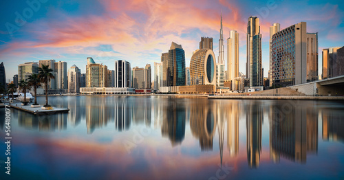 Vászonkép Dubai skyline with reflection at dramatic sunset,  UAE