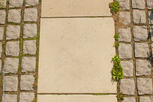Granite tiles in gray color close-up. The road paved with paving slabs of large and small sizes.