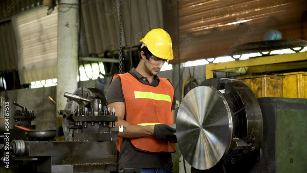 Workers wearing safety gear using a grinding machine steel in factory. Professional workers in the industry. Concept Blue collar Workers wearing safety gear using a grinding machine steel in factory. Professional workers in the industry. Concept Blue collar
