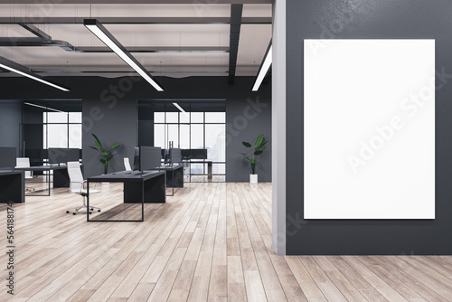 Modern coworking office interior with blank mock up banner on wall, wooden flooring, windows, equipment, furniture and other items. 3D Rendering.