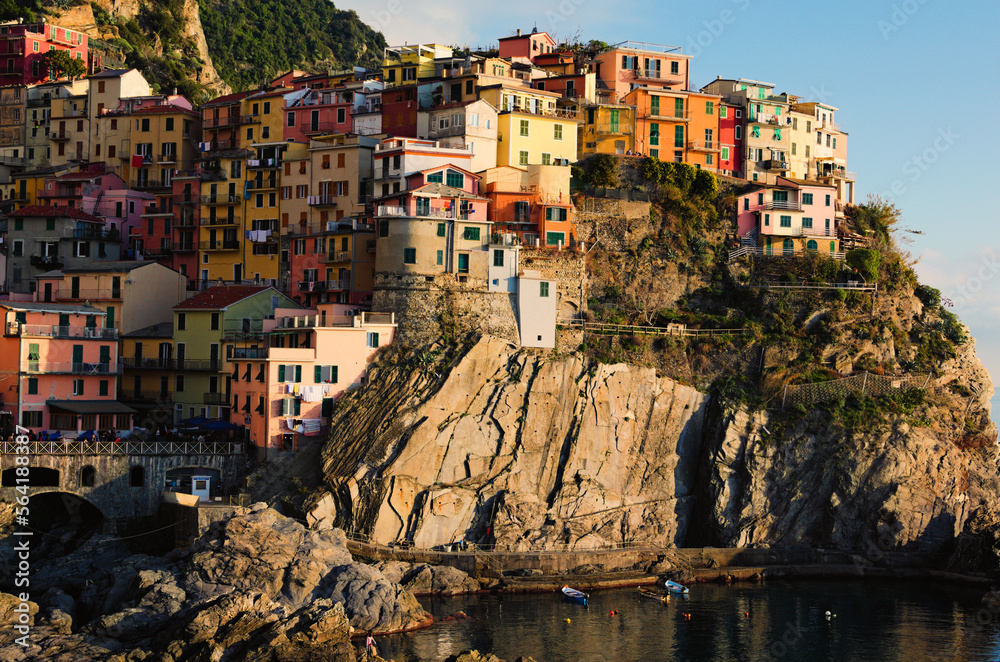 Small village built on the rocks. Manarola. Village between mountains and the Ligurian sea. Famous touristic place and travel destination in Italy. The Cinque Terre. UNESCO World Heritage Site