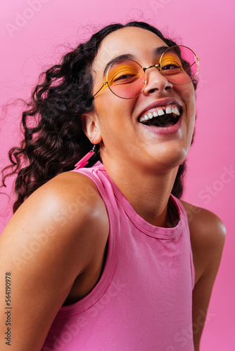 Creative studio portrait of beautiful hispanic woman with diastema - Cool, modern and unique female adult posing on colorful background, concepts about diversity, individuality and fashion © oneinchpunch