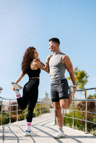 Couple stretching outdoors before morning run