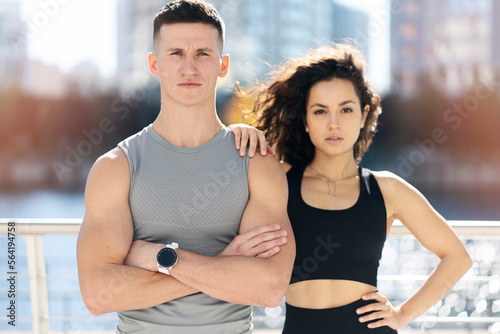 Portrait view of the man and woman after fitness exercise on the street background