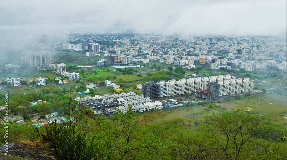 A clear top view of City in India from top of the mountains during rainy season.