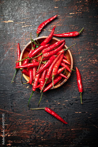 Wooden plate with hot chili peppers. 