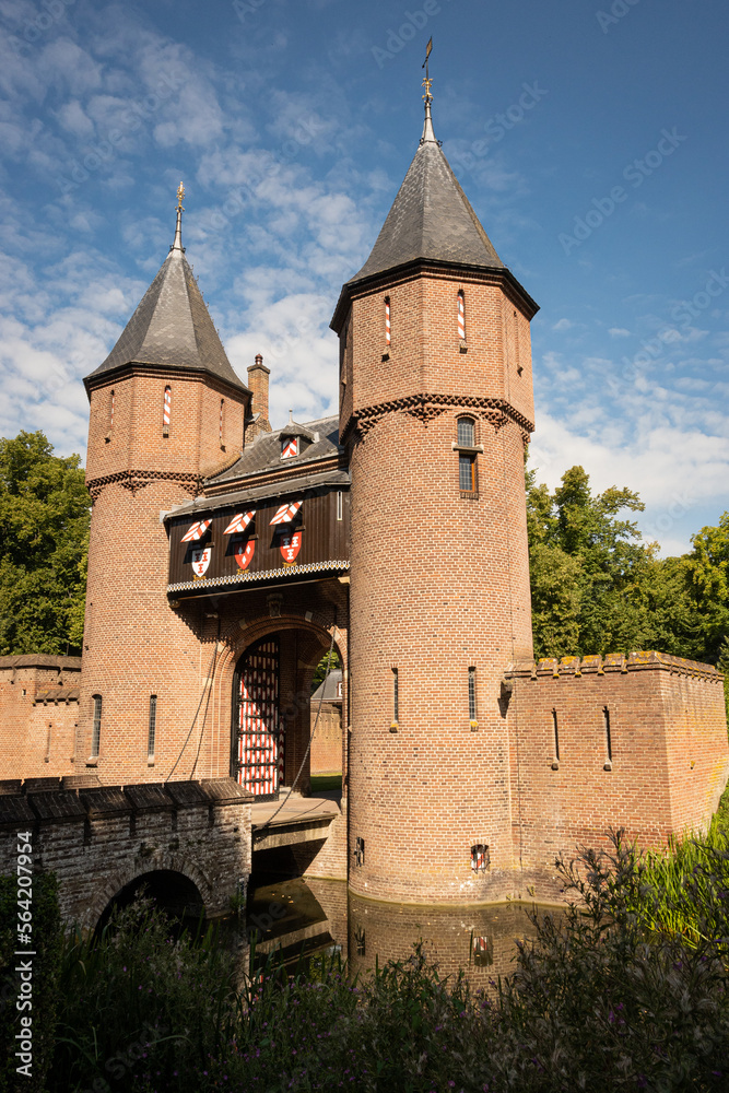 outside entrance gate of Kasteel De Haar Dutch medieval castle on sunny summer day. Shutters have colour of Utrecht Netherlands where historic building with European architecture is located