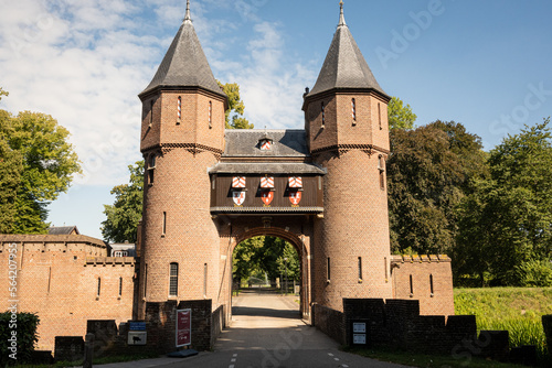 outside entrance gate of Kasteel De Haar Dutch medieval castle on sunny summer day. Shutters have colour of Utrecht Netherlands where historic building with European architecture is located photo