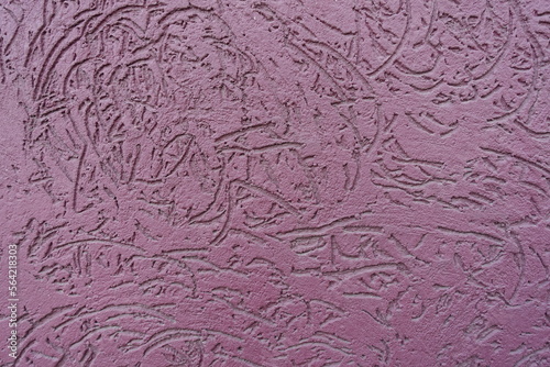Fototapeta Naklejka Na Ścianę i Meble -  Macro of dusty purple wall with stucco worm finish