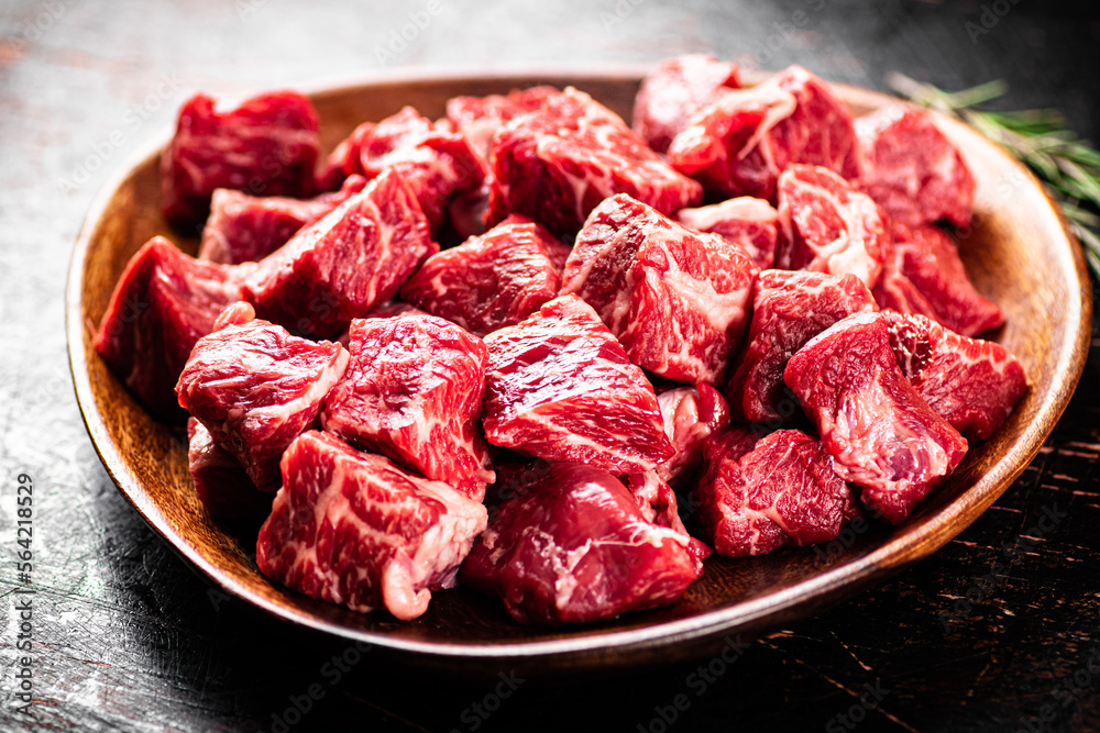 Chunks of fresh raw beef on a plate. Chunks of fresh raw beef on a plate.