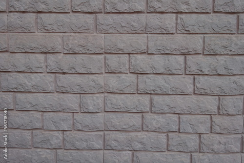 Pale grayish pink painted brick veneer wall texture
