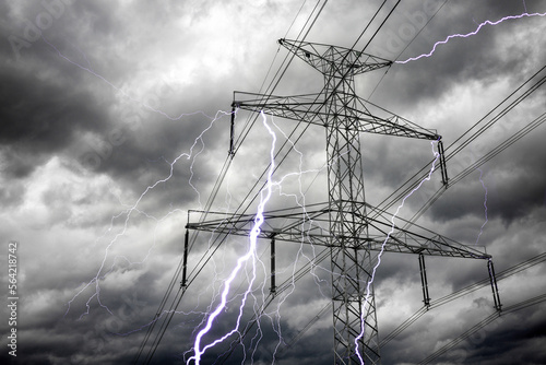 Bright lightning bolts from electric power pylon tower.  Electricity discharge clouds