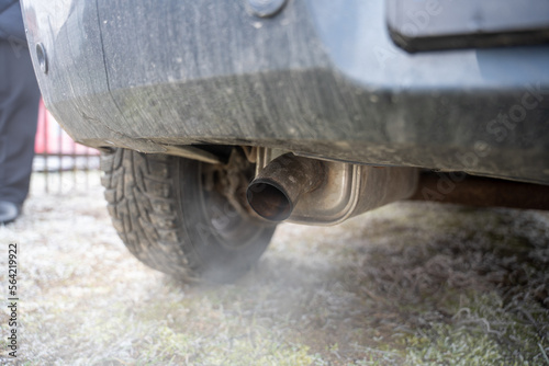 Close-up of white smoke emerging from exhaust pipe on gas powered automobile
