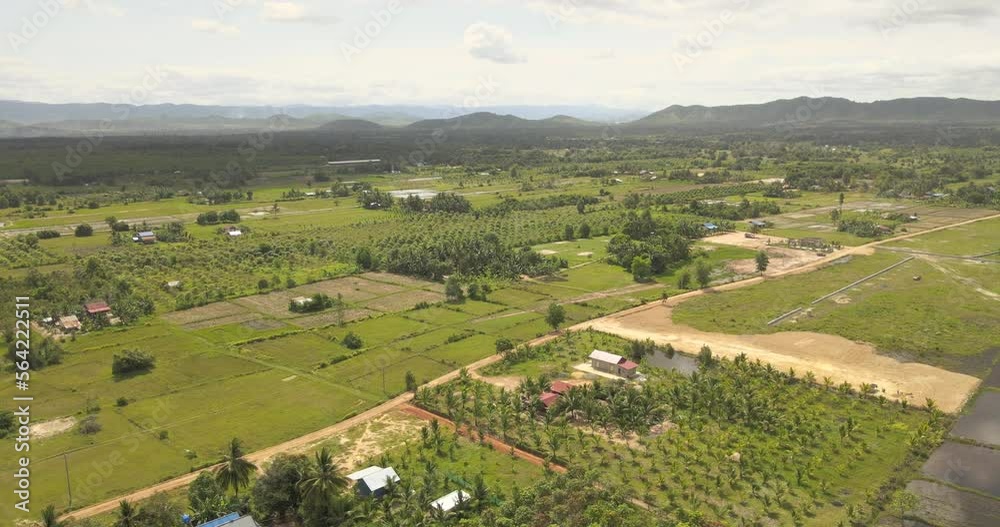 aerial drone shot of agricultural fields. Mountains as backdrop aerial drone shot of agricultural fields. Mountains as backdrop
