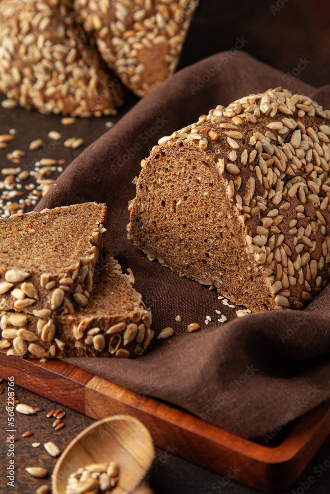 Fresh homemade bread with seeds on a warm background. Vertical photo Fresh homemade bread with seeds on a warm background. Vertical photo