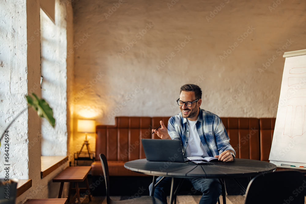 An adult businessman talking with one client online, working ove An adult businessman talking with one client online, working ove