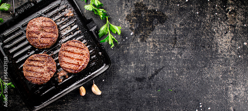 Grilled burger in a frying pan. 