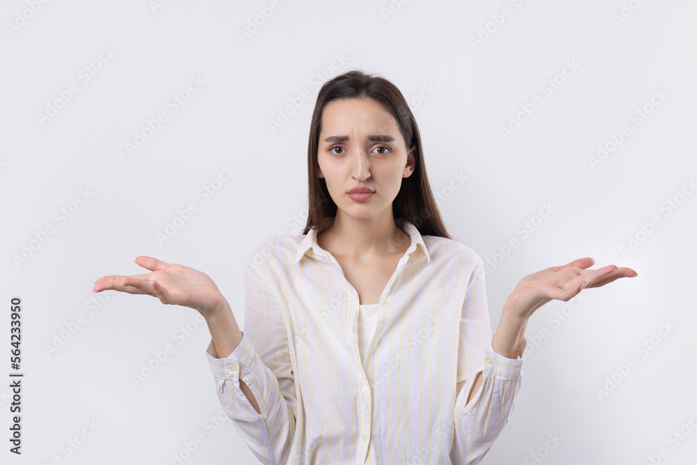 Young beautiful woman with facial expression of surprise standing over white background. Young beautiful woman with facial expression of surprise standing over white background.