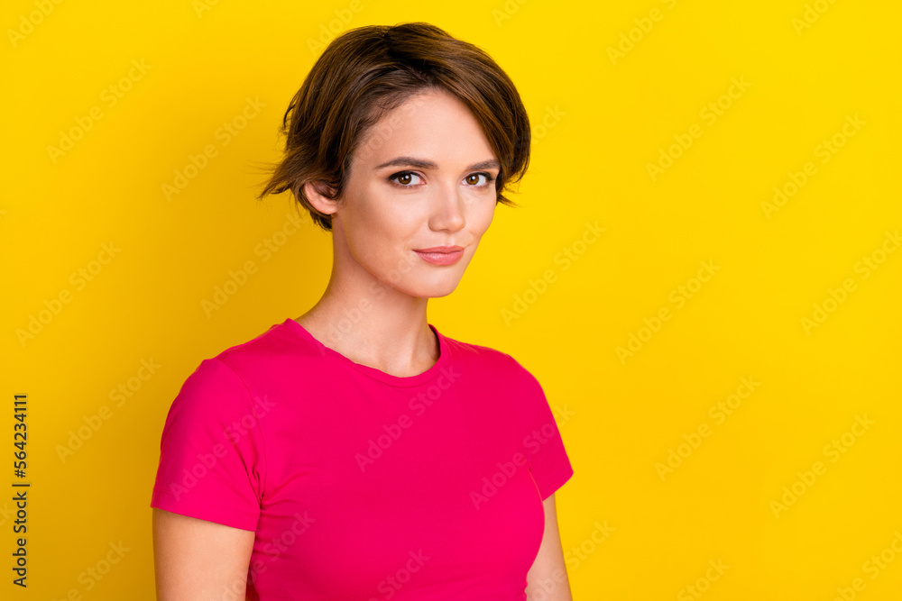 Photo of serious confident calm lady wear comfort bright clothes stand near empty space isolated on yellow color background Photo of serious confident calm lady wear comfort bright clothes stand near empty space isolated on yellow color background