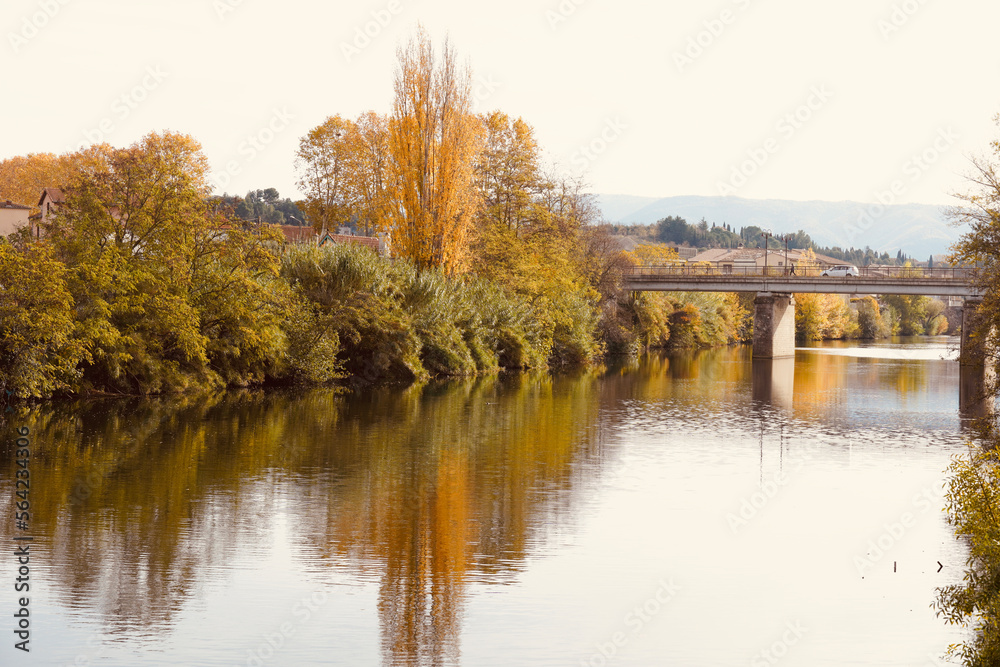 Autumn views of the bridge of Limoux, river aude. Limoux city in southwestern France, in the Occitania region of the department of Aude. Autumn landscape reflections on the water.
