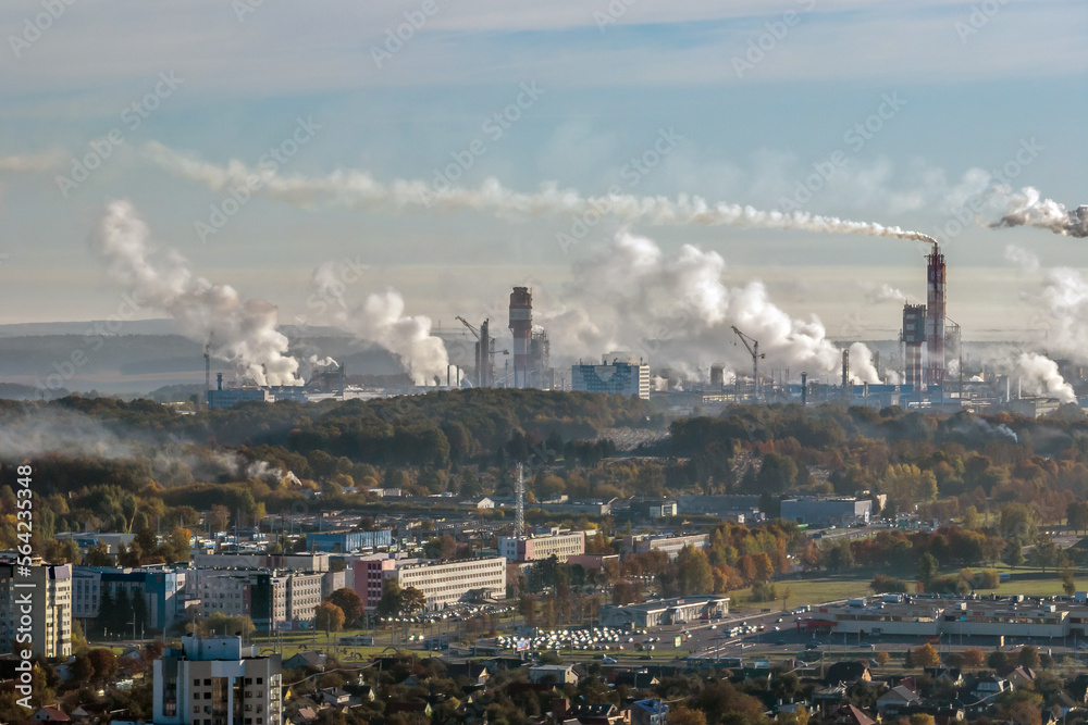 panoramic aerial view of the smoke of pipes as background of huge residential complex with high-rise buildings and private sector . Air and water pollution concept