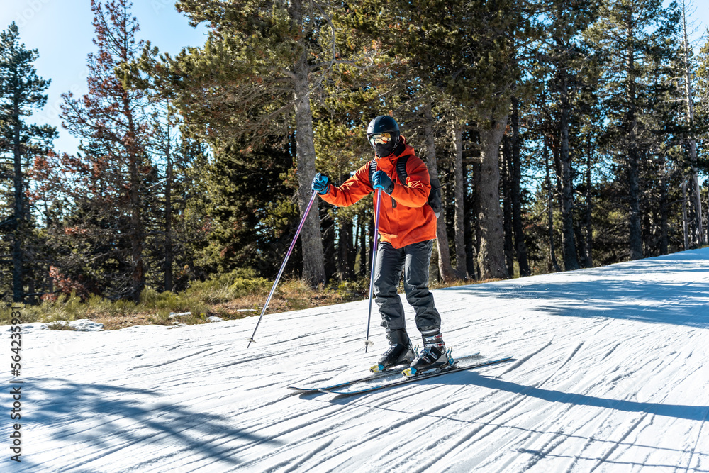 A boy skiing on a ski slope.