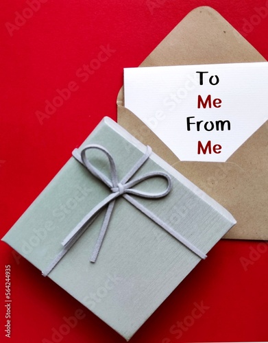 Gift box with craft envelope and card note written FROM ME - TO ME, concept of buy yourself a gift, give yourself love and attention you deserve photo