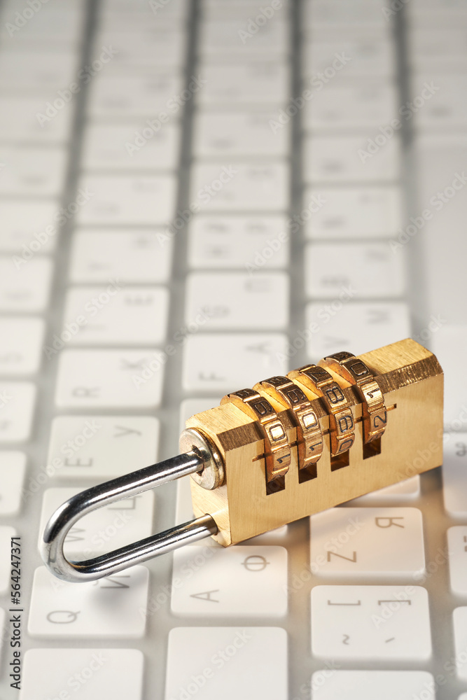 computer security and strong password concept, dial combination lock on keyboard background computer security and strong password concept, dial combination lock on keyboard background