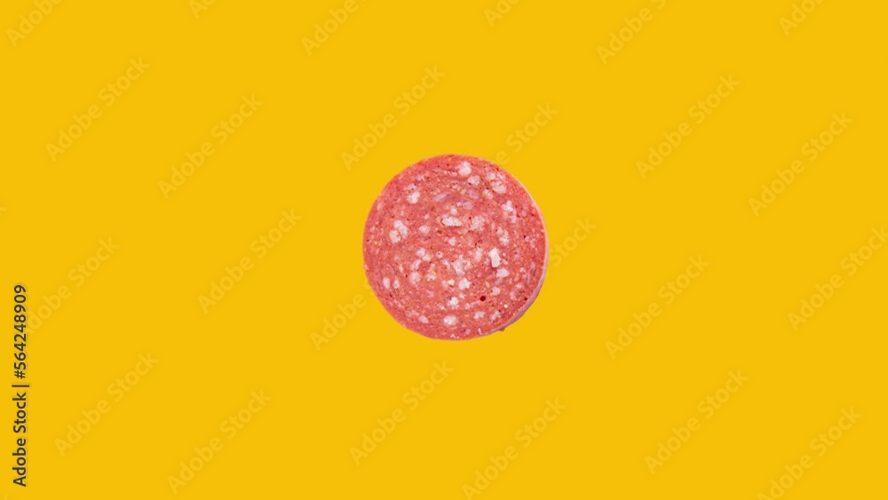 Slice of sucuk rotation on yellow background. Turkish meat product sucuk. Slice of sucuk rotation on yellow background. Turkish meat product sucuk.