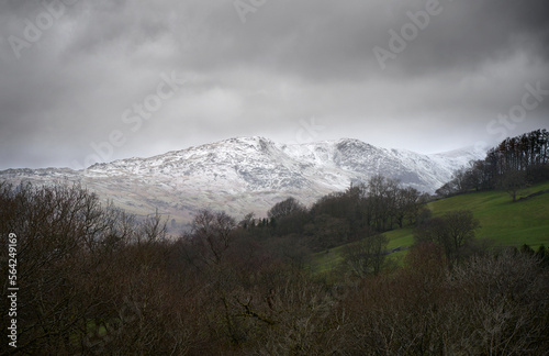 Mountain summits of Heron Pike and Great Rigg covered in snow from below Wansfell Pike in the Cumbrian Lake District Mountains, England UK. photo
