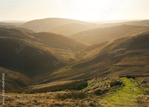 Obraz na płótnie The twisting valley of Rowhope Burn from the summit of Black Braes on a sunny winters morning in the Northumberland Cheviot mountains at sunrise, UK. w salonie