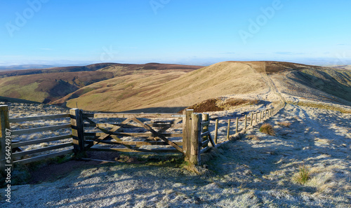 Views of Mozie Law and the fence of the Scottish Border from Windy Gyle on a sunny but frosty winters morning in the Northumberland Cheviot mountains at sunrise, UK. photo