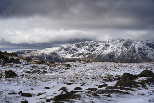 The snow covered mountain summit of Crinkle Crags from Langdale Pikes in the Cumbrian Lake District Mountains, England UK.