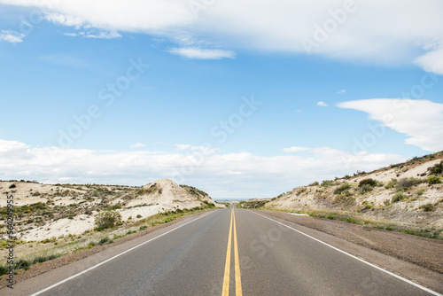 Empty straight road in desert mountains