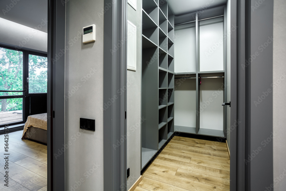 Modern gray scandinavian loft wood walk in closet with wardrobe