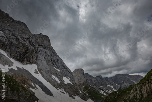 Mountain hiking Trail Road. Grey sky before thunderstorm. Between Italy and Austria: near Volaia Lake Raunchkofer Mountain (Lago di Volaia Monte Rauchkofel) © ILLYA