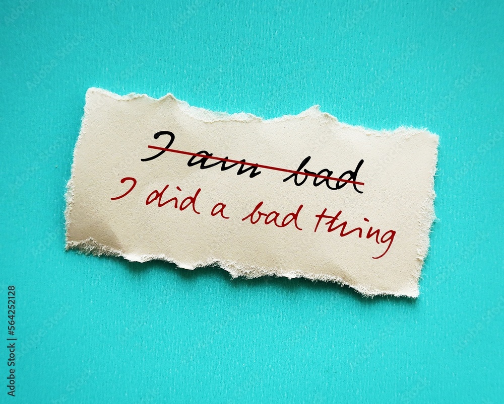 Torn stick note on red background with handwritten text I AM BAD ...