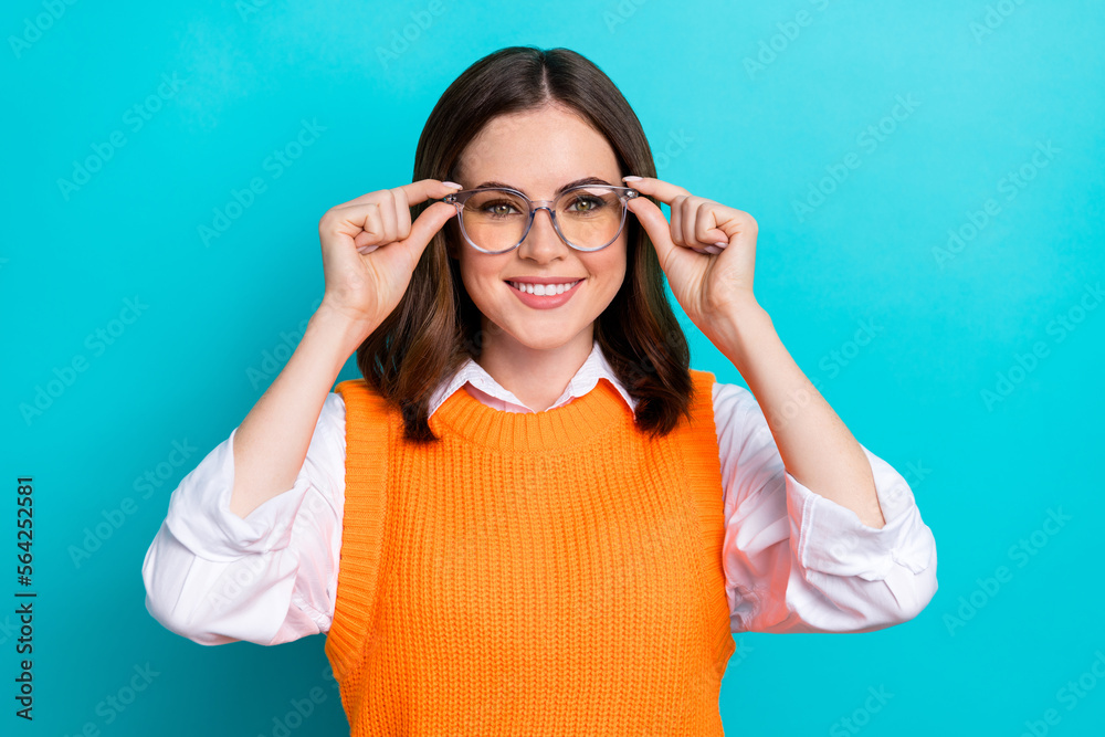 Photo of cheerful specialist woman with straight hairdo wear orange waistcoat hands touch glasses isolated on teal color background Photo of cheerful specialist woman with straight hairdo wear orange waistcoat hands touch glasses isolated on teal color background