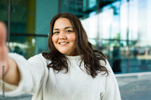 Attractive big hispanic woman taking a selfie photo