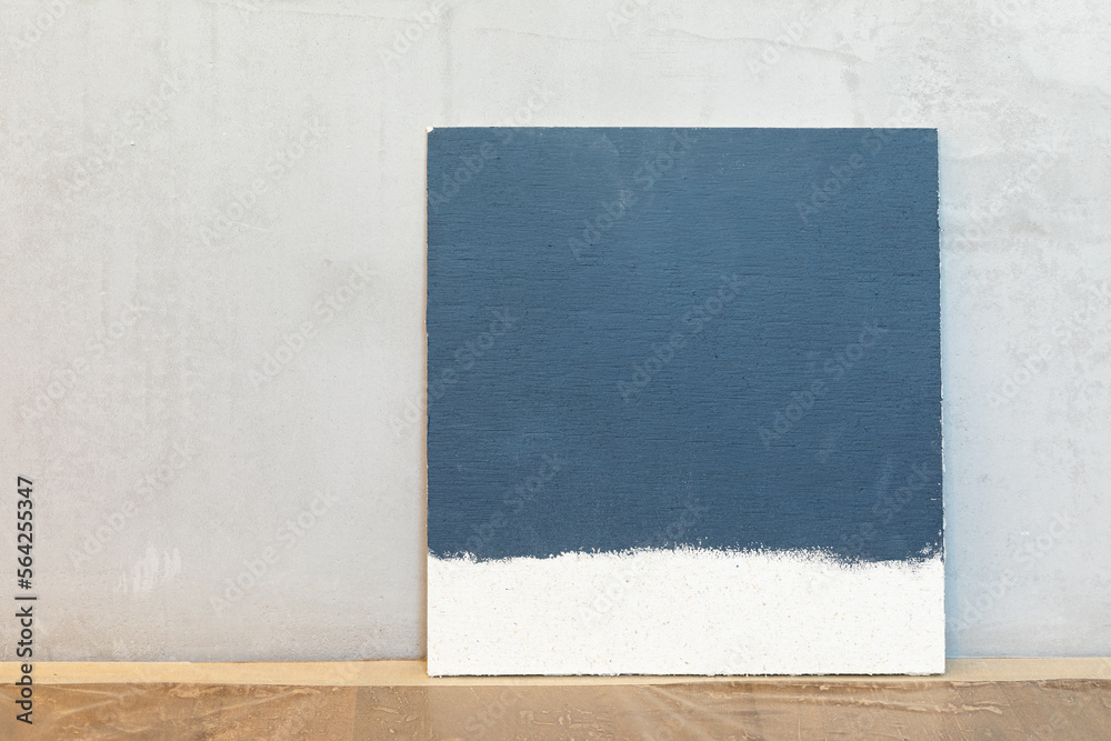 Fototapeta premium Grey color sampler at a blank plaster wall