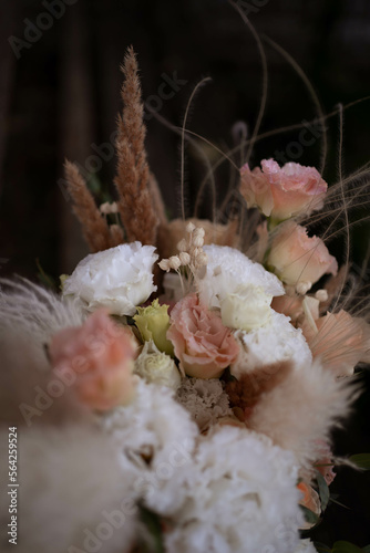 Beautiful wedding bouquet in vintage style. Boho bridal bouquet composed of lisianthus, pampas grass, roses and dried flowers. Wedding day.