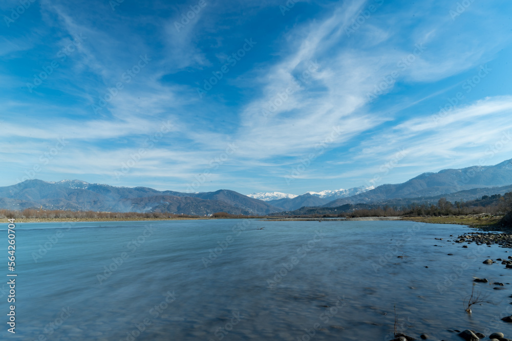 Wide angle view of Chokhori river. Mountainous range in the background. Beatiful nature landscape.