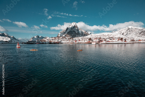 fishing village in Lofoten, Norway, Epic snowy mountains and red cabins with water, beautiful background picture from wild nature, clear sky and clouds  © Dominik