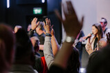 Hands in the air of people who praise God at church service