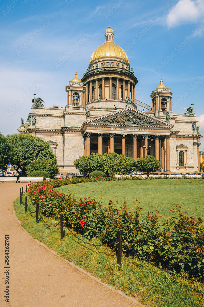 Panoramic view on Saint Isaac's Cathedral. Isaakievskiy Sobor with green lawn and red roses in summer, St. Petersburg, Russia. vertical photo. High quality photo