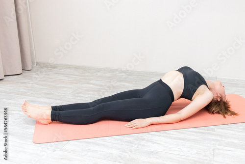 Woman doing yoga exercises at home