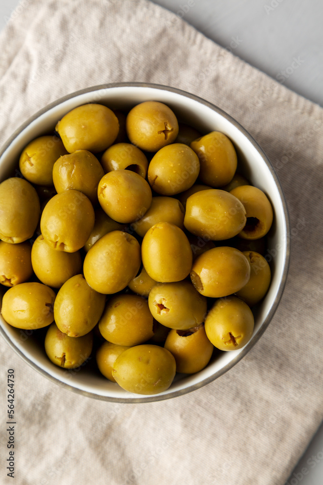 Marinated Green Pitted Olives in a Bowl, top view. Flat lay, overhead, from above. Marinated Green Pitted Olives in a Bowl, top view. Flat lay, overhead, from above.