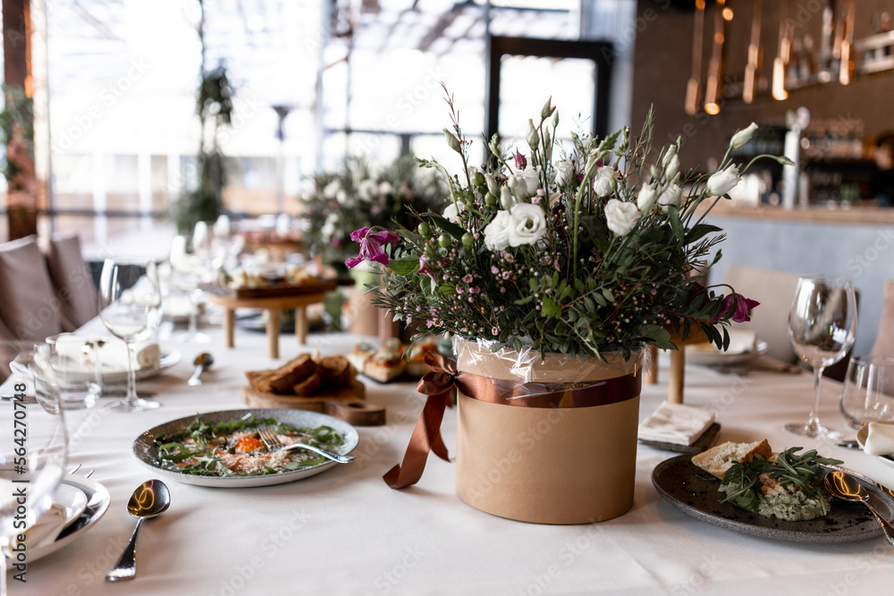 food and decoration of flowers on a festive table in a restaurant